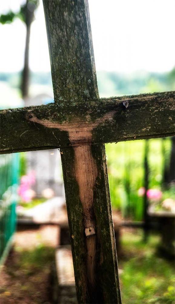 Cemetery cross with missing Jesus. Looks a little feminine.